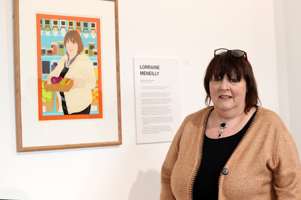 Nominee Lorraine Meneilly standing in front of her portrait in the Naughton Gallery