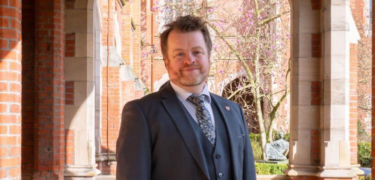 Man standing in the cloisters of Queen's University Belfast