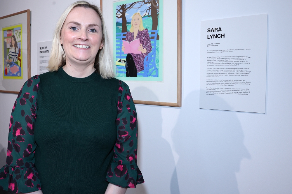 Nominee Sara Lynch standing in front of her portrait in the Naughton Gallery