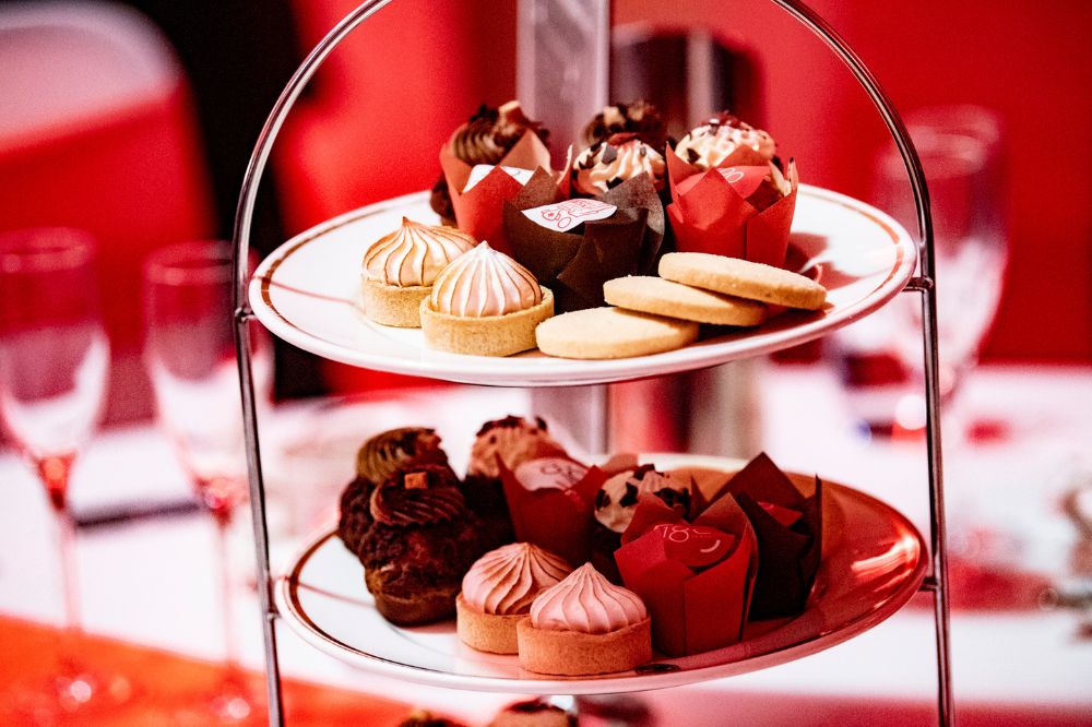 sweet treats presented in afternoon tea style on a table at an indoor event