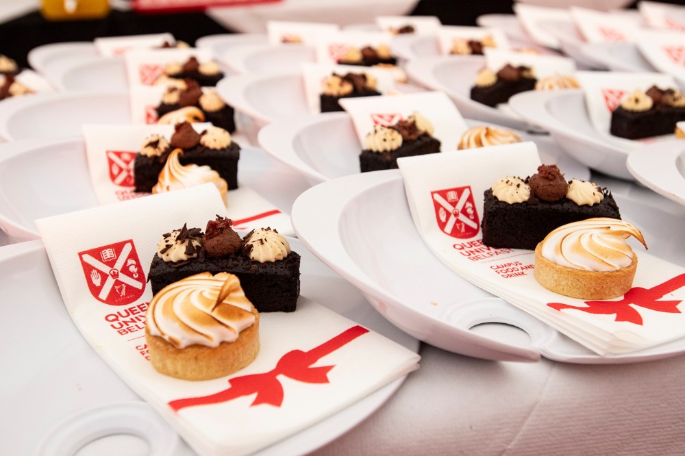chocolate and meringue-based cake desserts laid out on a buffet table